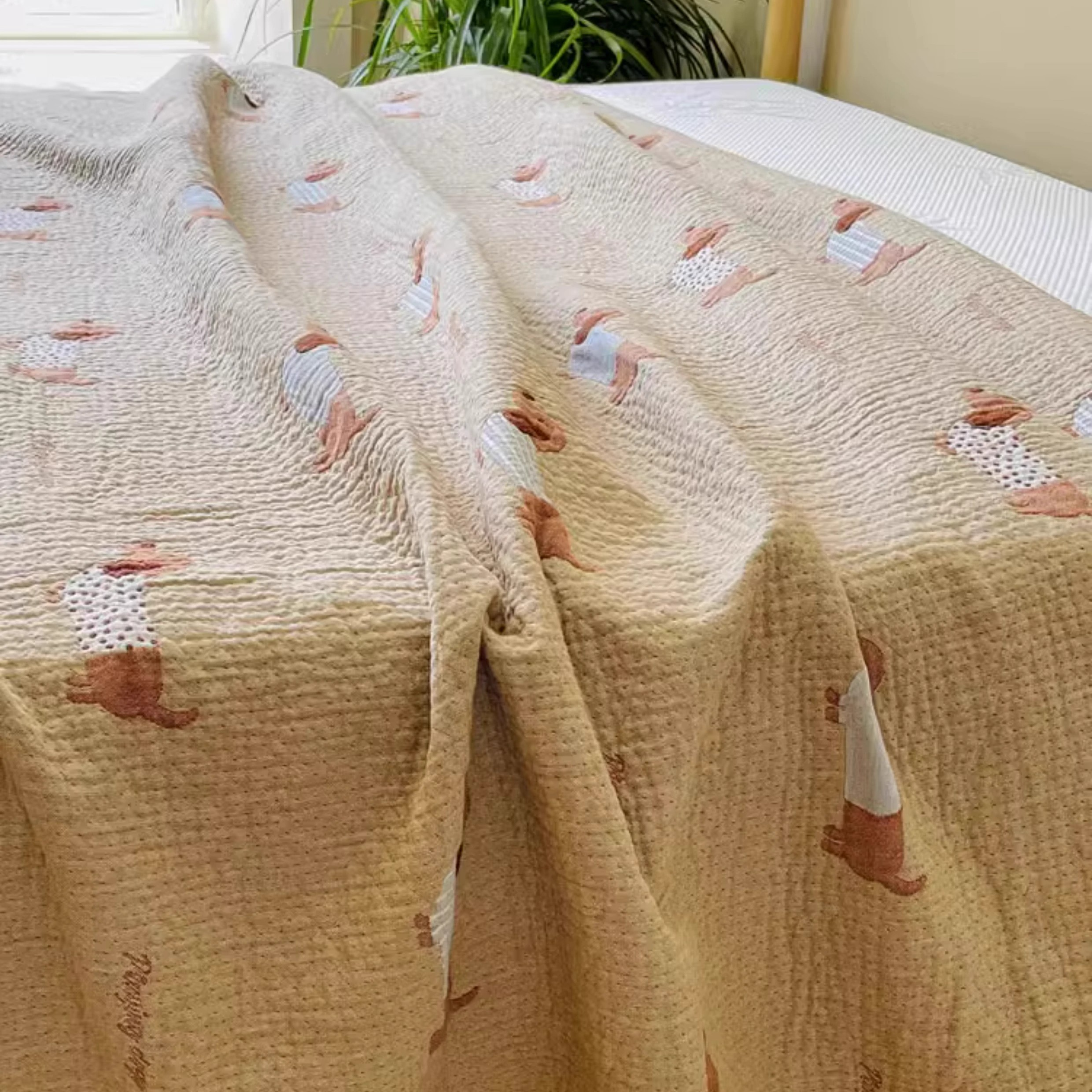 Close-up of Playful Pals Cotton Gauze Quilted Blanket Puppy showing dachshund dog illustration on cotton gauze texture