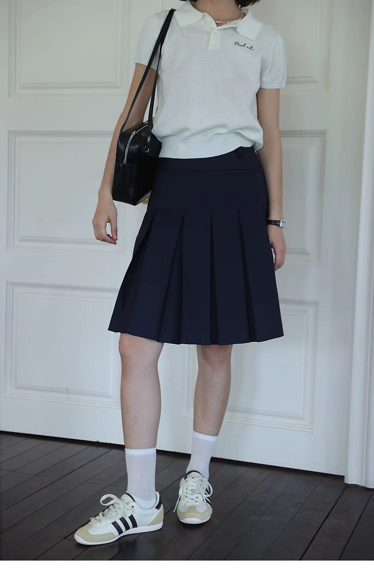 Pleated Chic Skirt navy blue front view highlighting clean pleated design and high-waisted structured fit