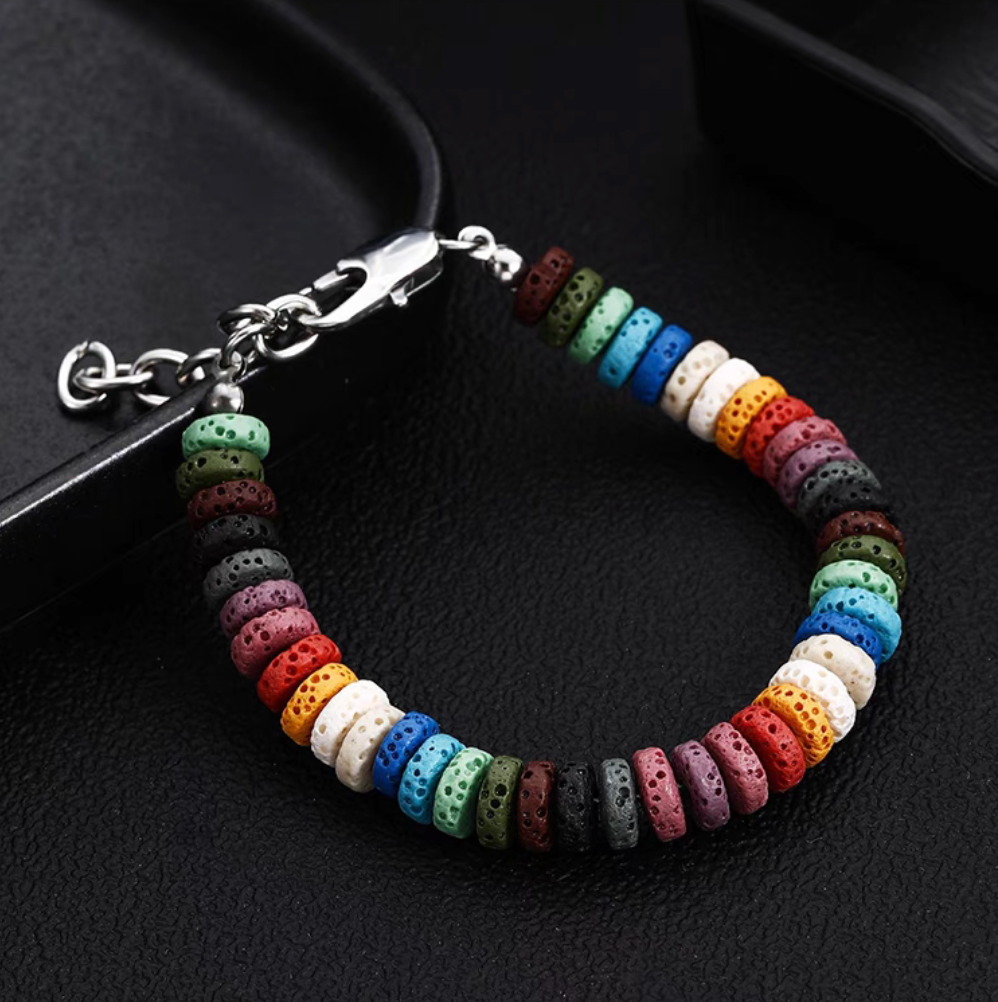 Close-up of plain style rainbow volcanic stone bracelet with colorful lava beads and titanium steel clasp detail