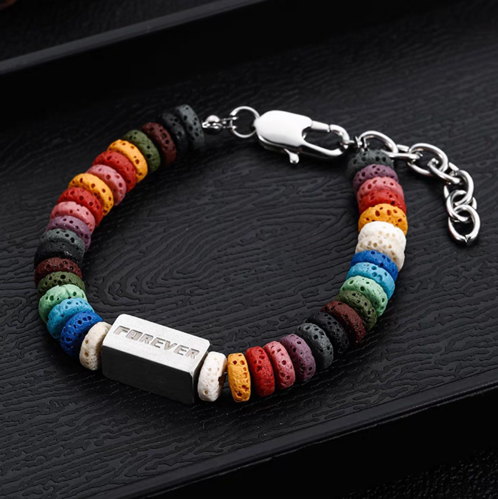 Angled view of square bead rainbow lava stone bracelet with engraved titanium steel bar and vibrant multicolor beads