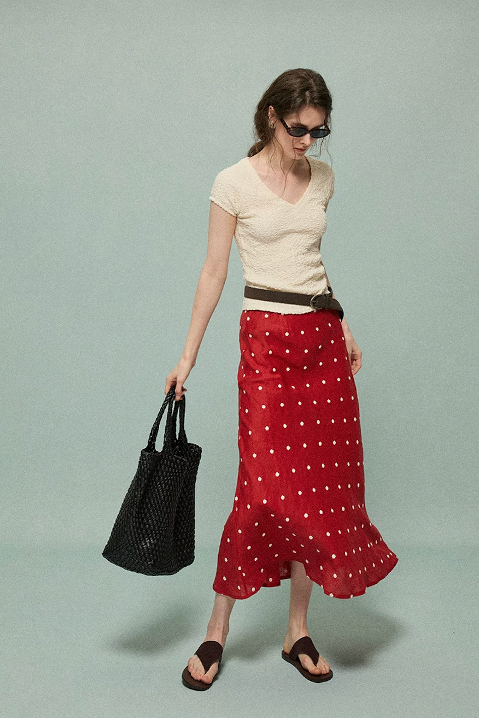 Full-length view of a red polka dot linen skirt with a gently flared hem