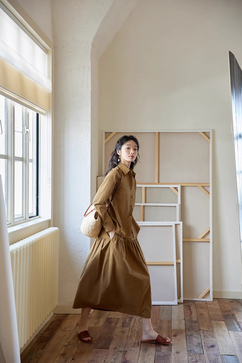 Side walking view of Earth Tone long-sleeve blouse and midi skirt set, showing natural movement, breathable cotton, and everyday comfort