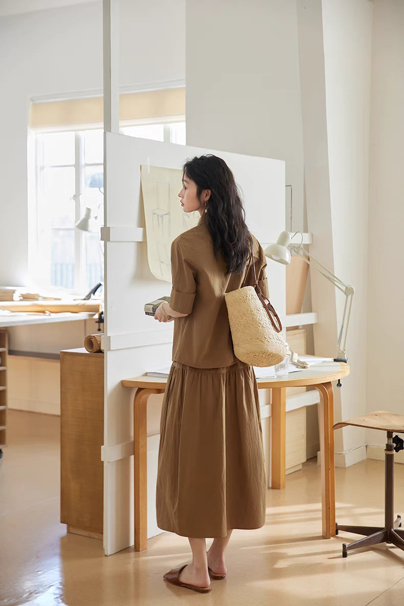 Back view of Earth Tone short-sleeve cotton set with woven bag, showcasing gathered skirt detail and relaxed fit silhouette