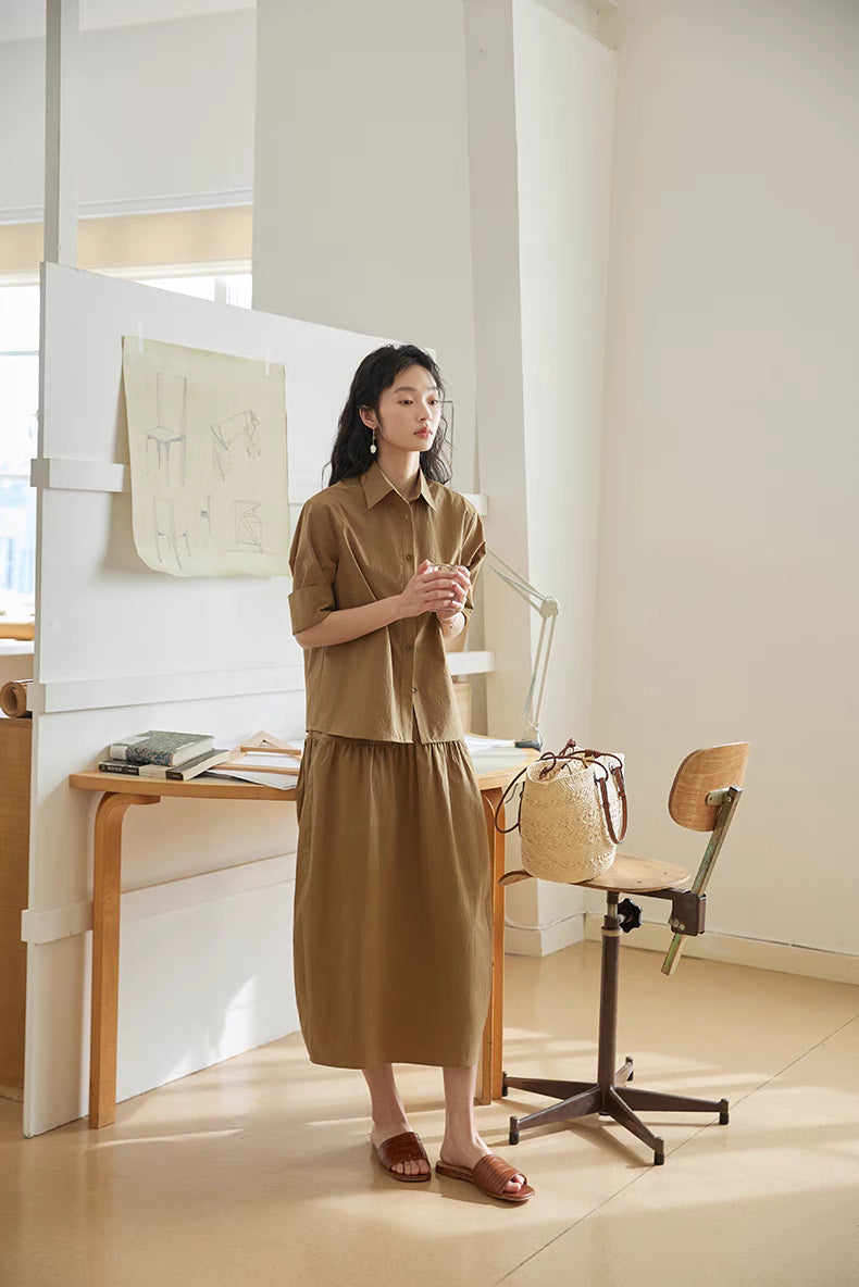 Earth Tone short-sleeve blouse and midi skirt set in studio setting, highlighting structured cotton fabric and effortless everyday outfit