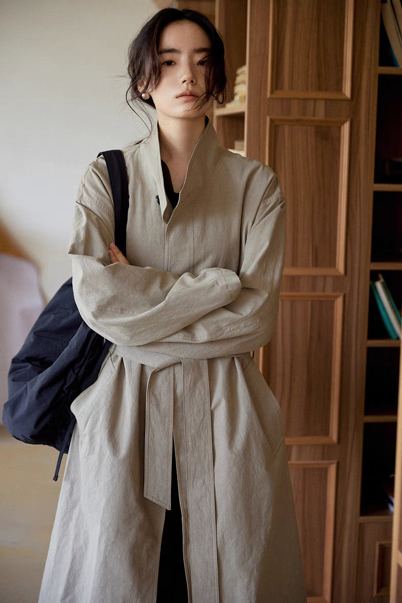 Close-up front view of woman wearing the gray Relaxed Cotton-Linen Trench, highlighting the detachable belt, stand collar, and soft naturally textured fabric