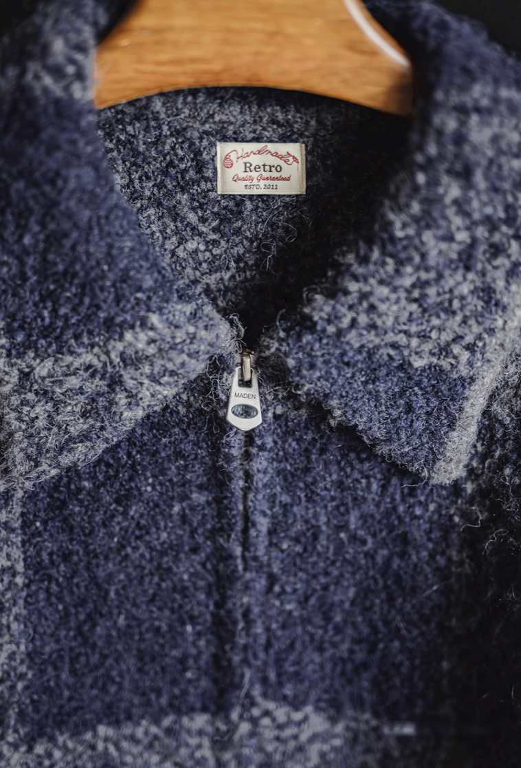 Close-up of jacket collar showing “Retro Handmade” label and zipper.
