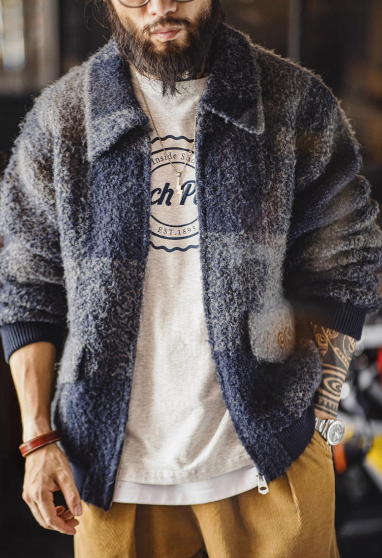 Model wearing navy gray plaid boucle jacket over T-shirt, front view.