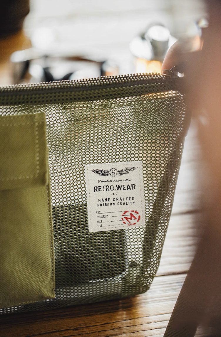 RETRO.WEAR handcrafted logo patch on vintage military-style green bag