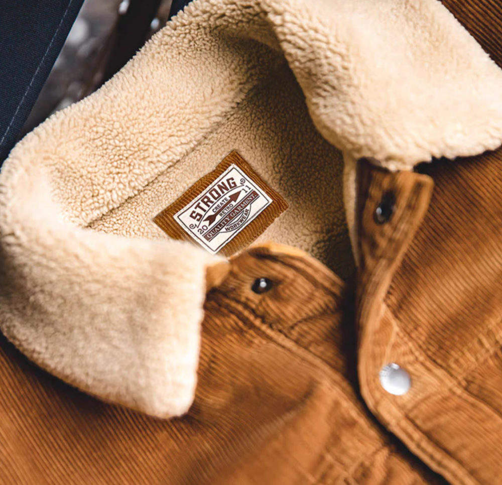 Close-up of Rust Corduroy Trucker Jacket with Sherpa Collar in Ginger Yellow highlighting sherpa lining corduroy texture and inner label