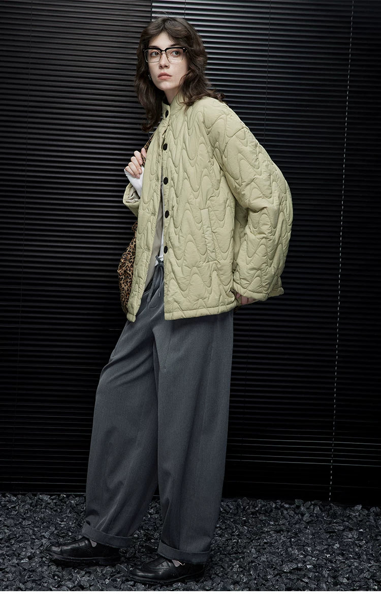 Full-length view of a Sage Green oversized down jacket with allover wave quilting