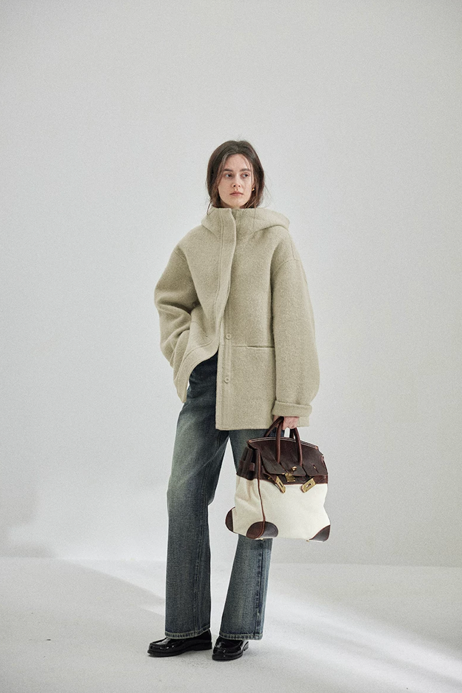 Full-length view of a Sage hip-length hooded wool coat with straight hem