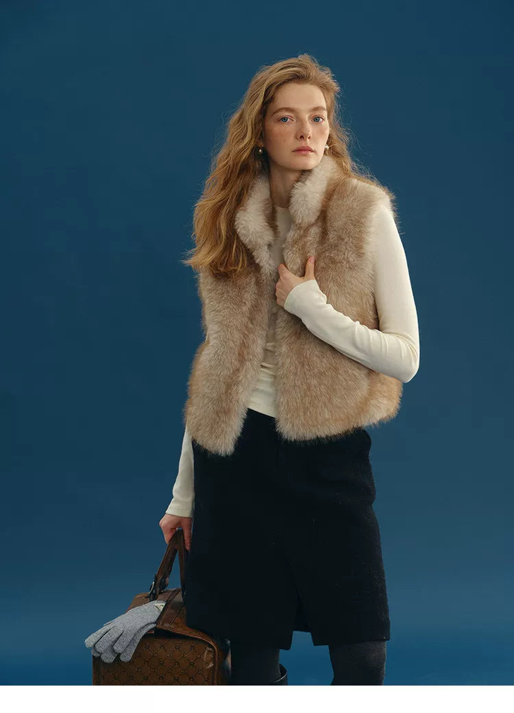 Sand cropped faux fur vest with stand collar worn over a cream long-sleeve top