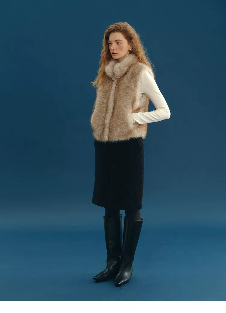 Full-length view of a Sand faux fur vest with stand collar and hand in hidden pocket