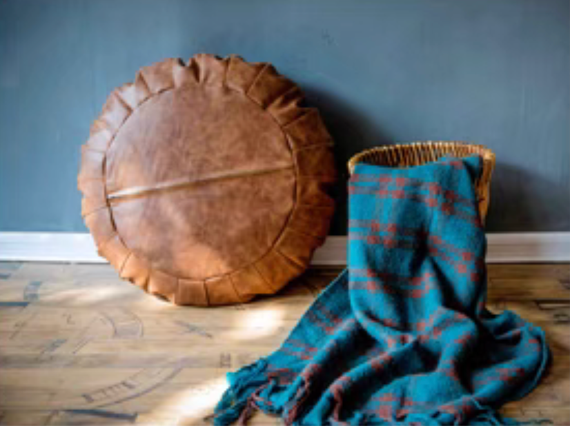 Back view of camel Scandinavian round floor cushion showing underside stitching and structure