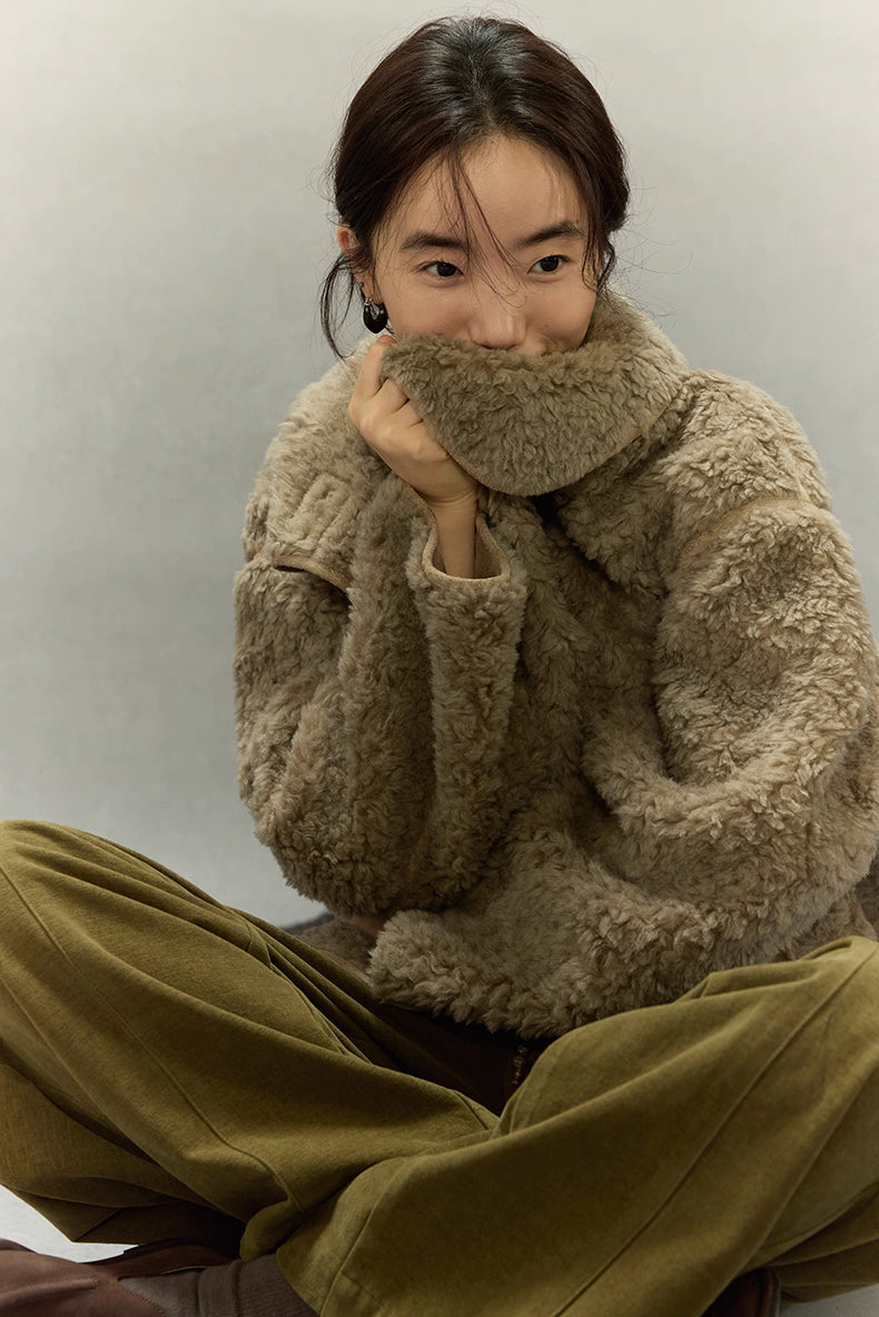 Woman covering mouth with sherpa collar showing plush texture
