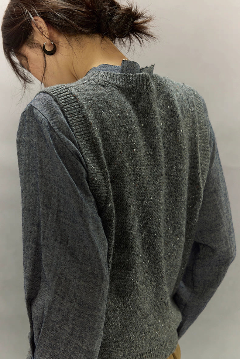 Back view of speckled wool-blend vest highlighting texture and shoulder seams.