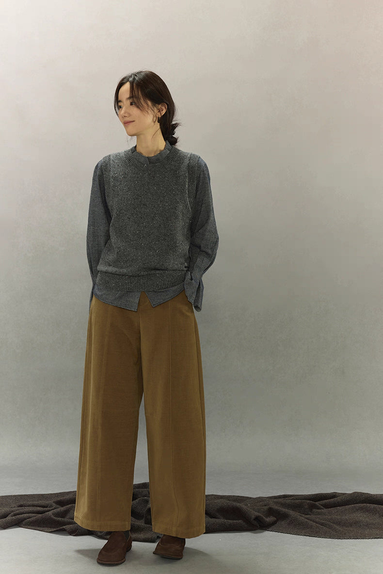 Full-body front styling of speckled wool-blend vest with relaxed trousers.