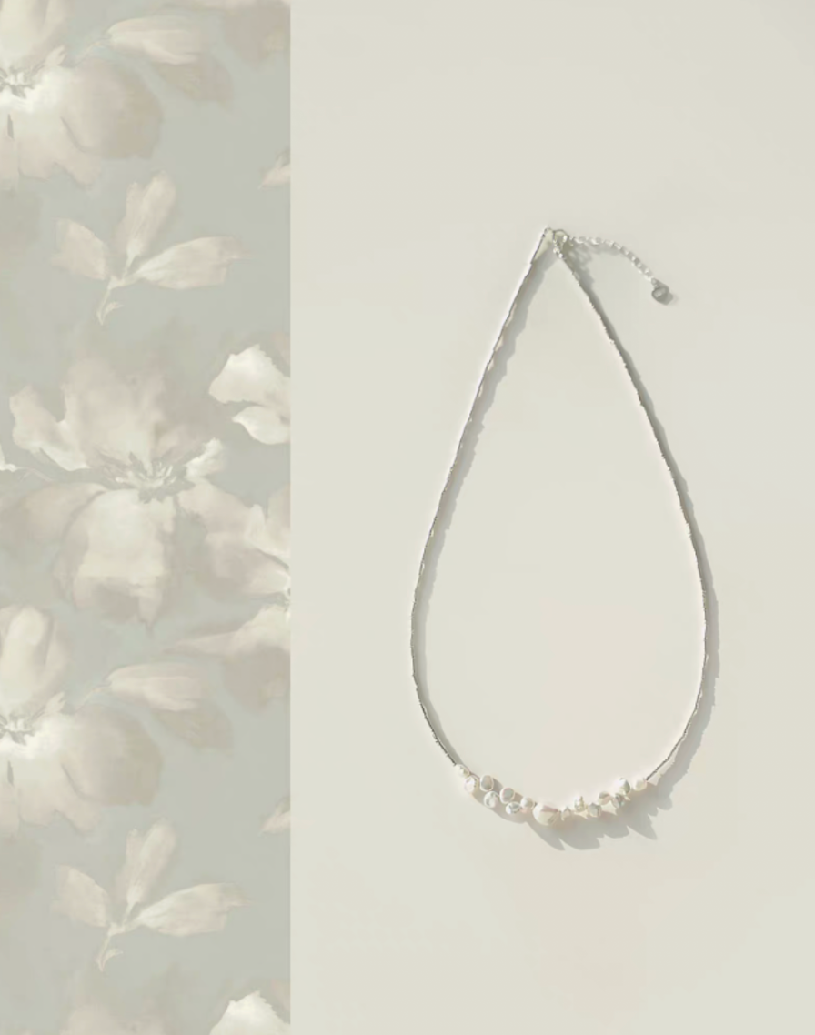 Soft white baroque pearl silver choker necklace full product view with delicate pearl cluster on white background