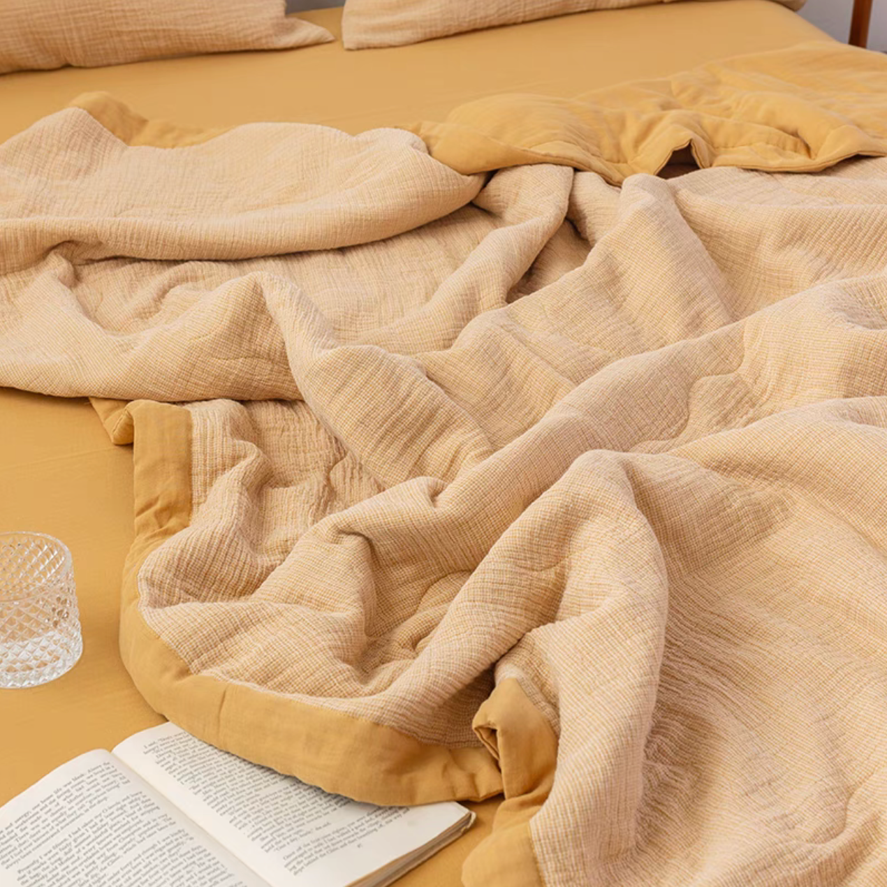 Mustard Yellow SoftNest cotton muslin bedding set draped across bed in warm minimalist bedroom setting