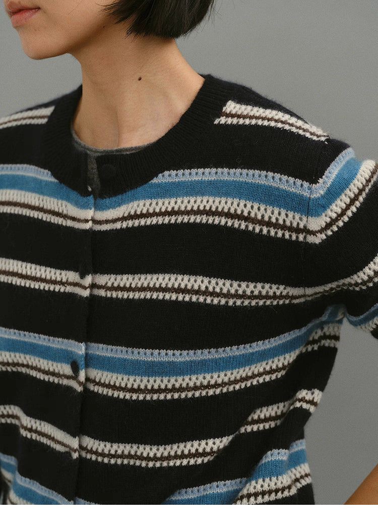 Close-up of the black-blue striped cardigan chest and neckline, highlighting knit texture and contrasting stripe pattern.