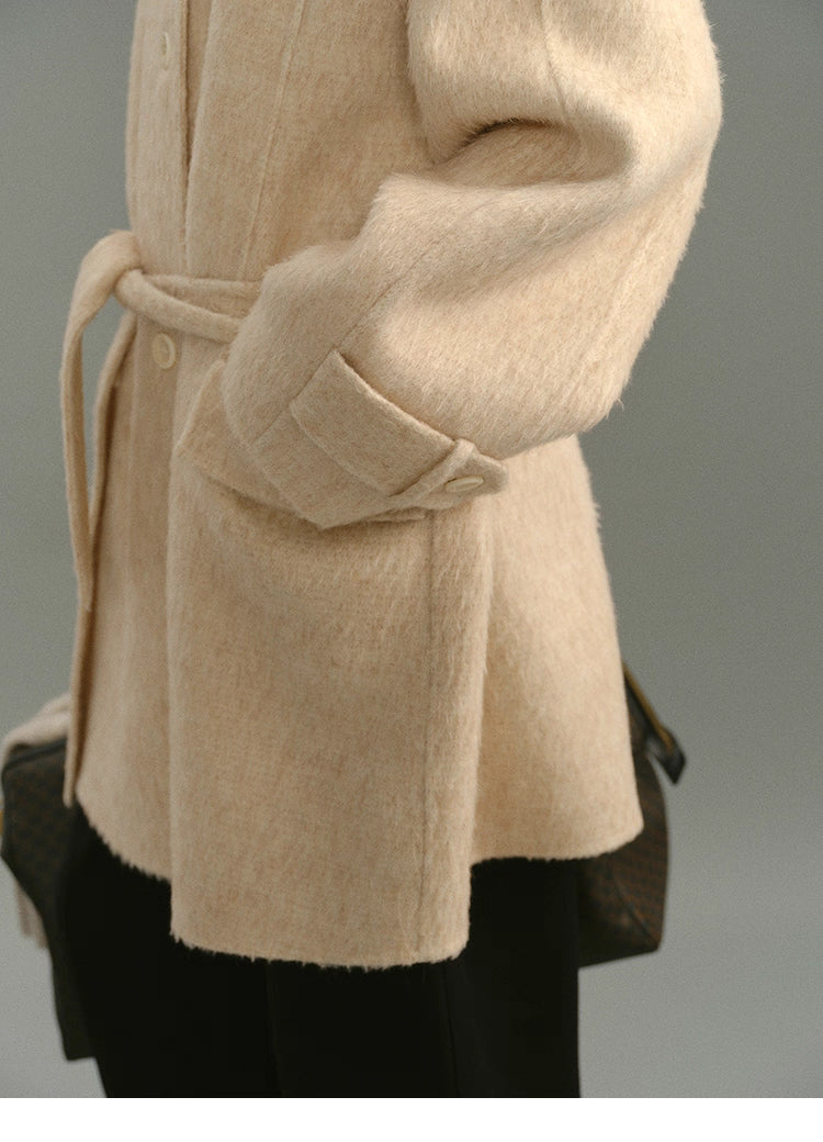 Close-up of sleeve cuff and pocket flap showing texture and stitching.