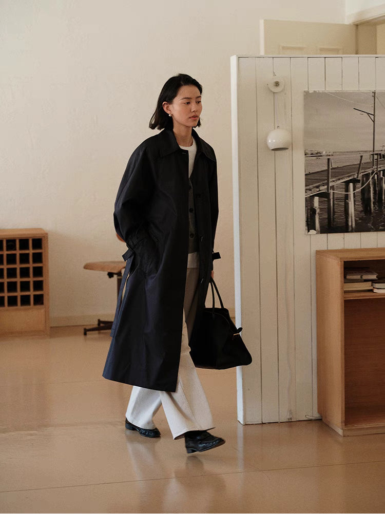 Dark Navy Blue Tailored Belted Trench Coat in walking pose showing full-length drape, relaxed fit and everyday styling