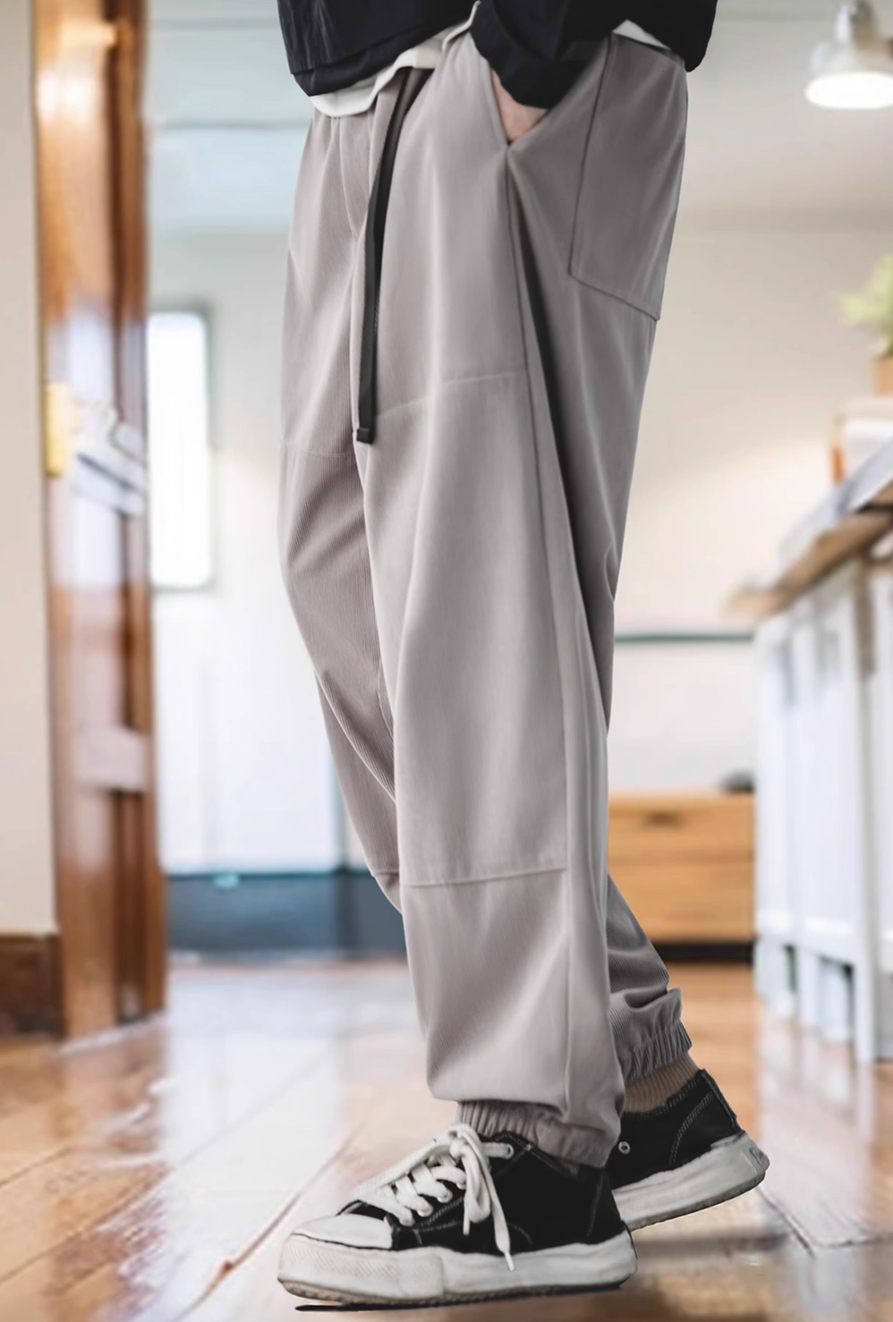 Side view of Textured Lounge Joggers in Light Gray highlighting corduroy fabric, relaxed tapered fit, elastic cuffs, and adjustable belt detail