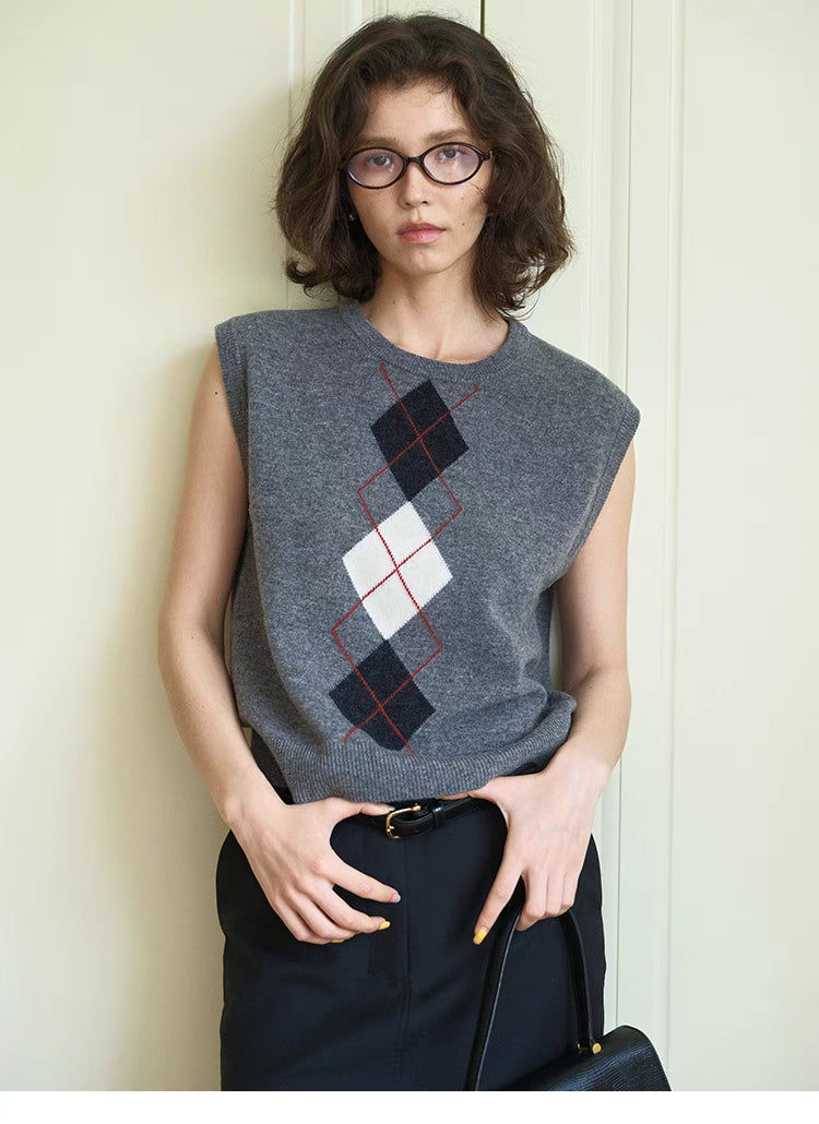 Light gray Timeless Wool Knit Vest styled with black skirt and belt, front view outfit with classic argyle knit pattern