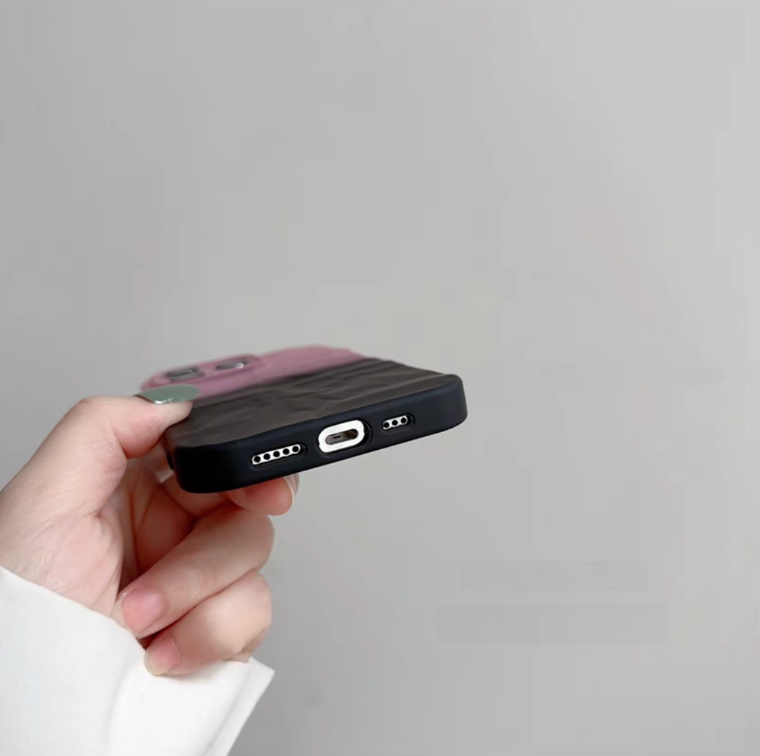 Pink and black phone case bottom detail with precise charging port and speaker openings