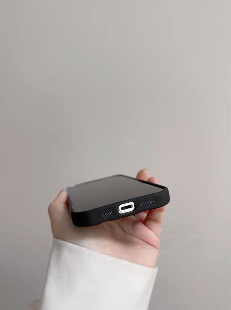 Silver and black phone case bottom detail with charging port and speaker cut precision