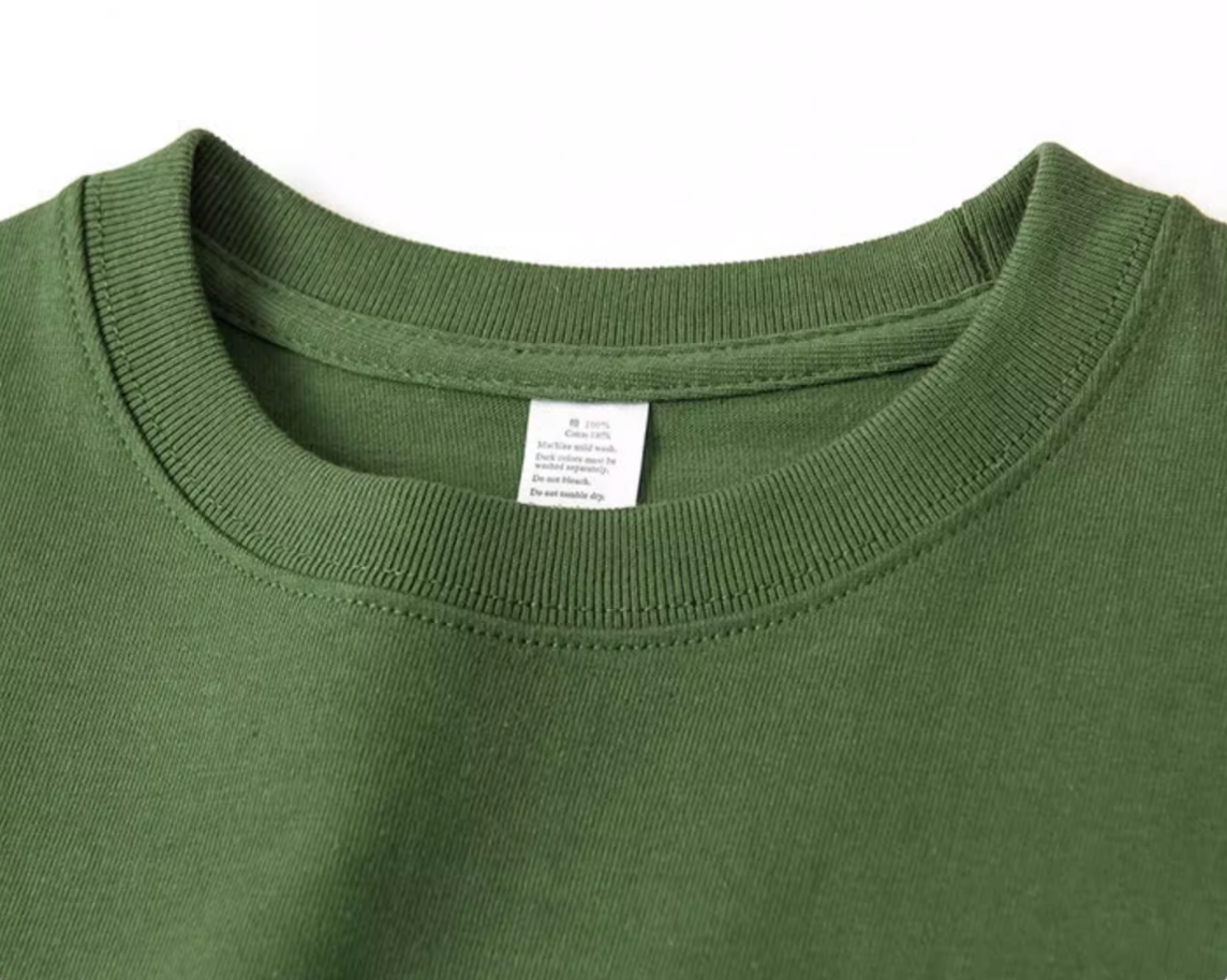 Urban Forest Tee avocado green crewneck collar close-up showing stitching and label detail