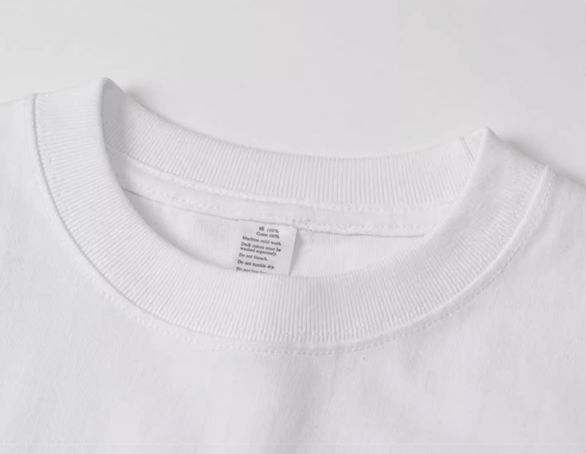 Urban Forest Tee white crewneck collar close-up showing stitching and label detail