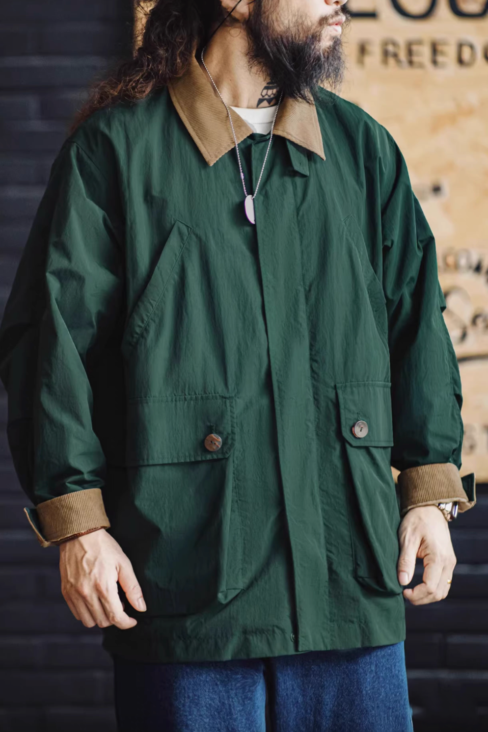 Man wearing Dark Green Utility Field Jacket front view showcasing relaxed fit, corduroy collar and oversized pocket design