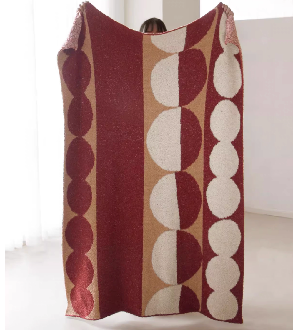 Red vertical geometric circle column plush knit throw blanket fully displayed with bold circular stripe pattern
