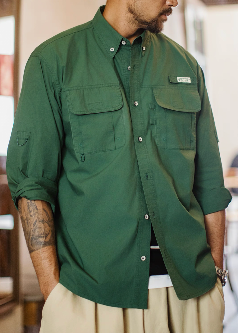 Side view of man wearing green Victory shirt showing button-down collar and chest pockets