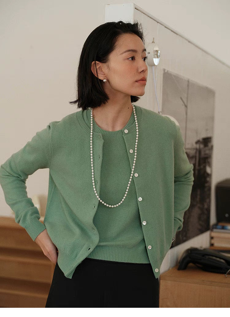 Vintage-Inspired Wool Cardigan in green, side profile on model styled with pearl necklace, lightweight wool layering outfit