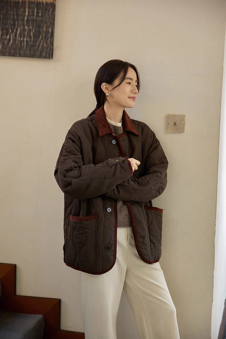 Angled side view of Vintage Meadow Jacket in dark brown green showing corduroy trim, snap button front, and casual countryside styling