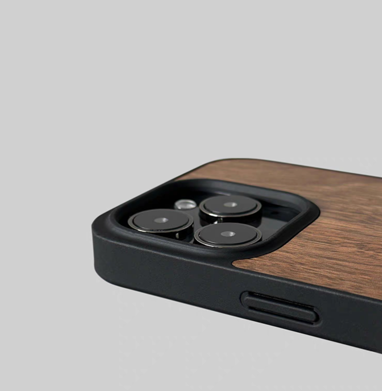 Close-up of walnut wood MagSafe phone case camera cutout with raised edge protection and wood finish detail