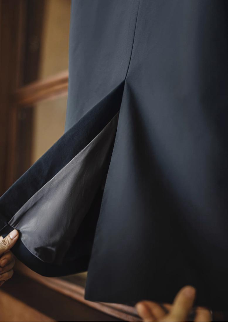 Back vent detail of navy waterproof Mac coat