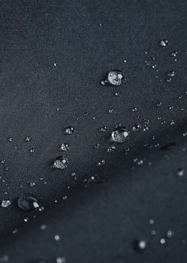 Water beads rolling off waterproof fabric of Mac coat