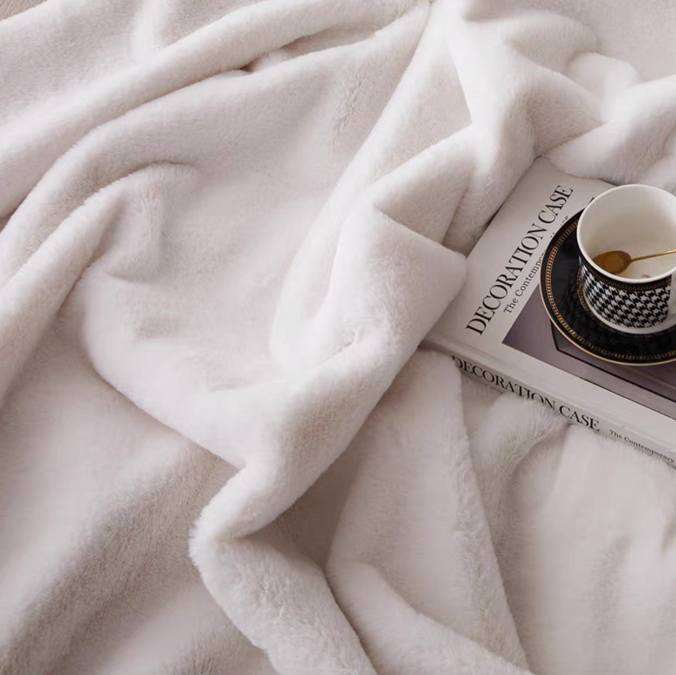 Close-up of white faux fur throw blanket highlighting ultra soft plush texture and thickness