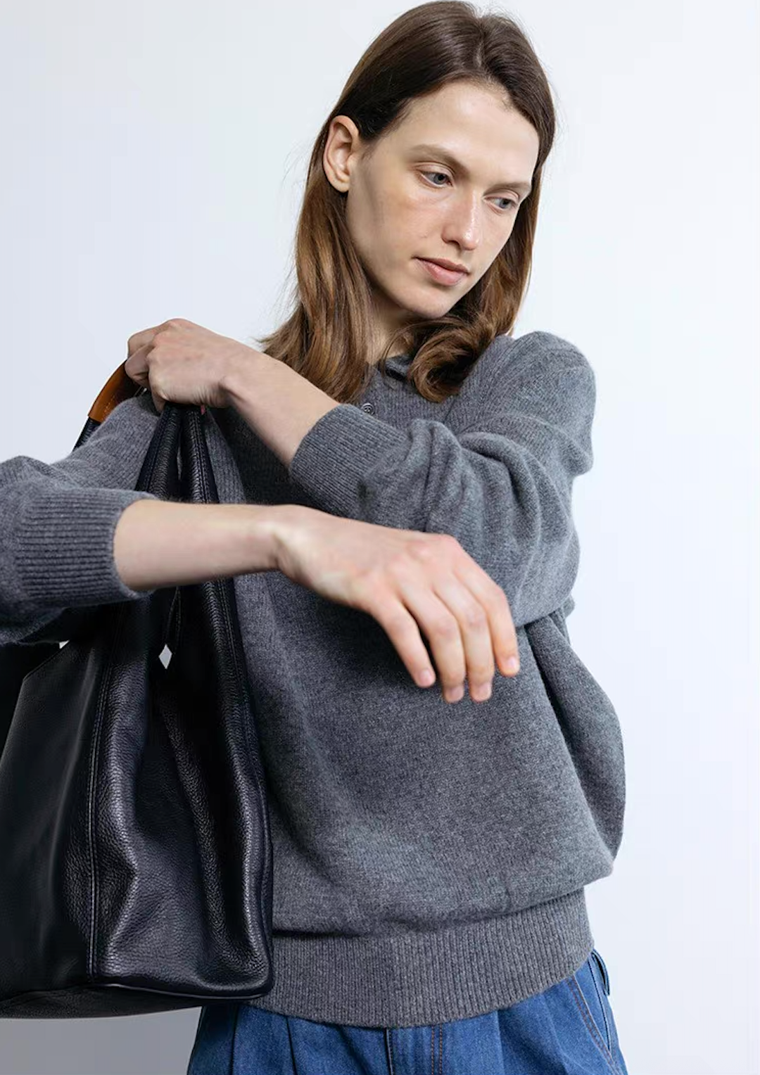 Dark gray wool cashmere polo sweater paired with black tote bag