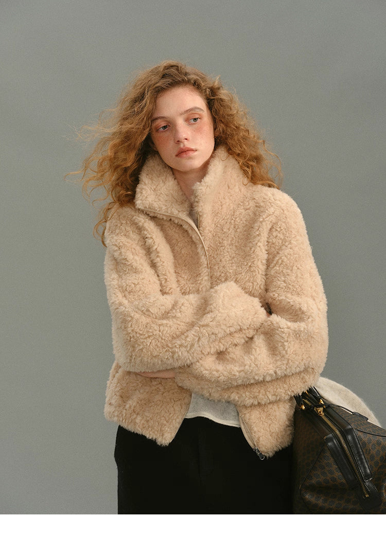 Close-up front view of cream beige 100% wool high-neck jacket with model crossing arms
