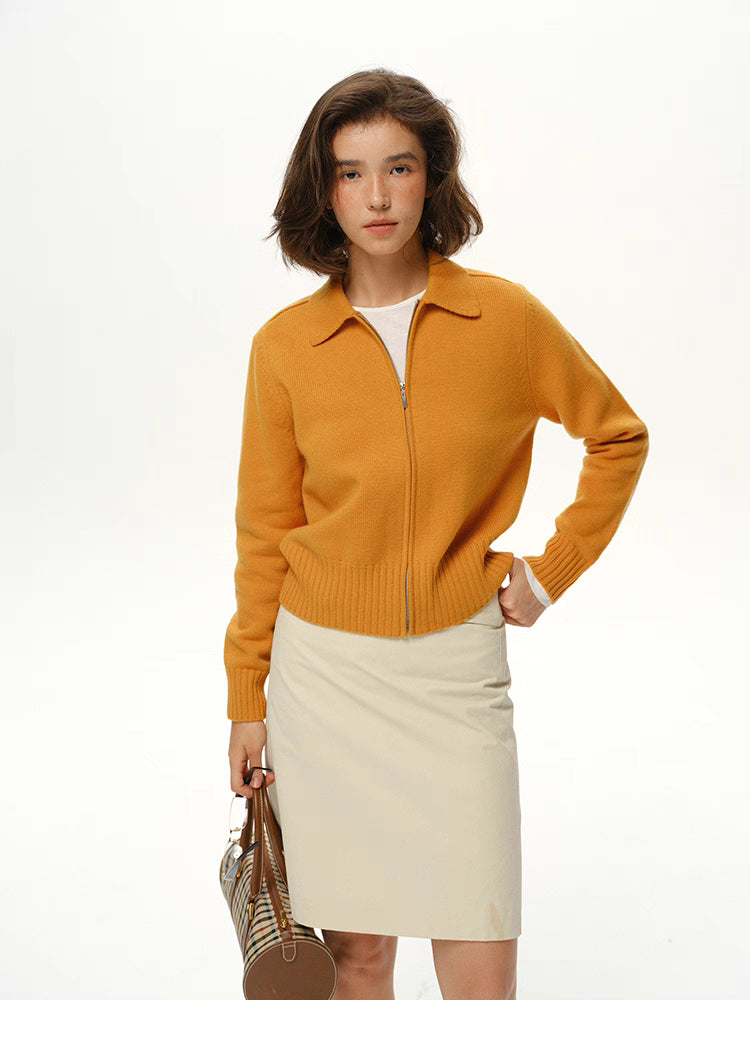 Mustard yellow wool zip collar knit jacket on model, front view with cream skirt on white background