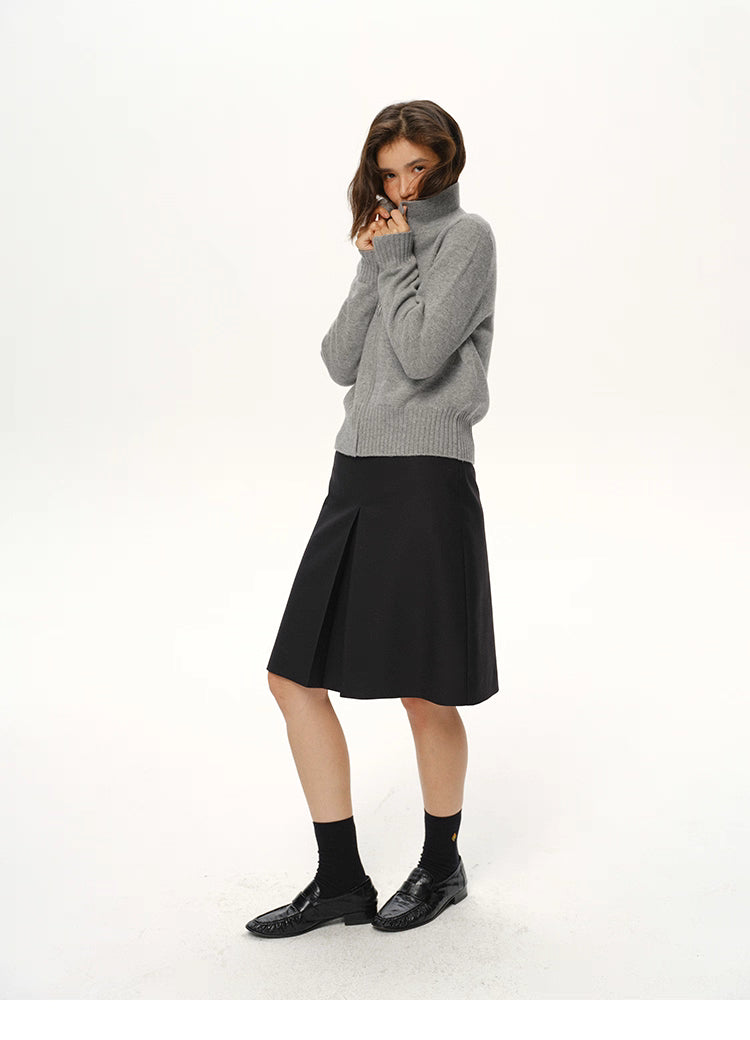 Medium grey wool zip jacket fully zipped to a cozy mock-neck, worn with black skirt