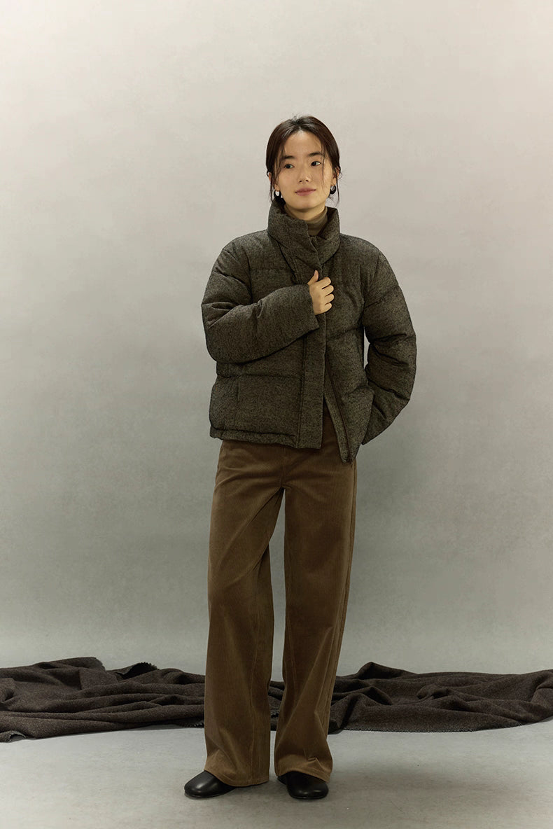 Full-body view of woman wearing wool-blend down jacket with wide-leg pants.