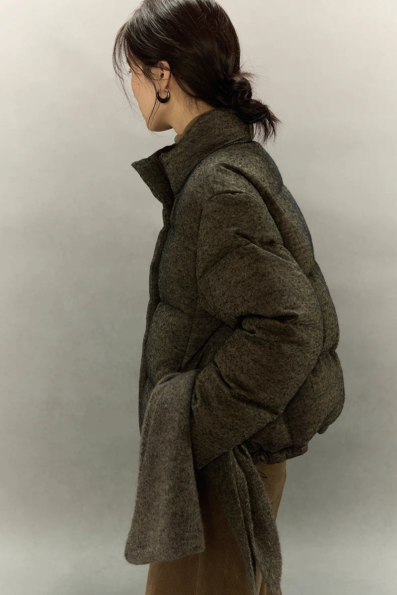 Side view of wool-blend down jacket showing sleeve volume and texture.