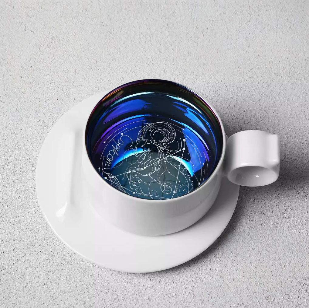 Capricorn zodiac ring handle coffee mug with saucer, top view featuring goat constellation line art inside iridescent glaze