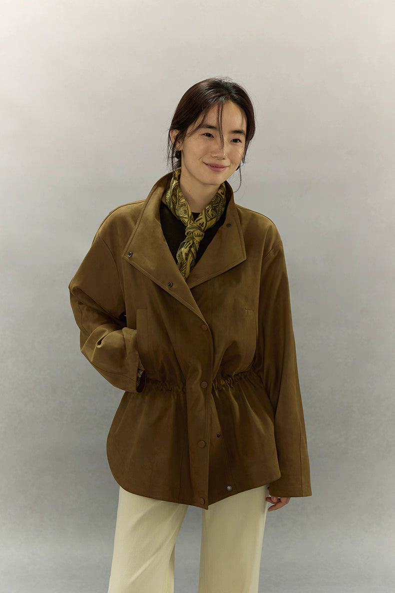 Model wearing caramel brown suede utility jacket with draped lapel front.
