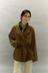 Model wearing caramel brown suede utility jacket with draped lapel front.